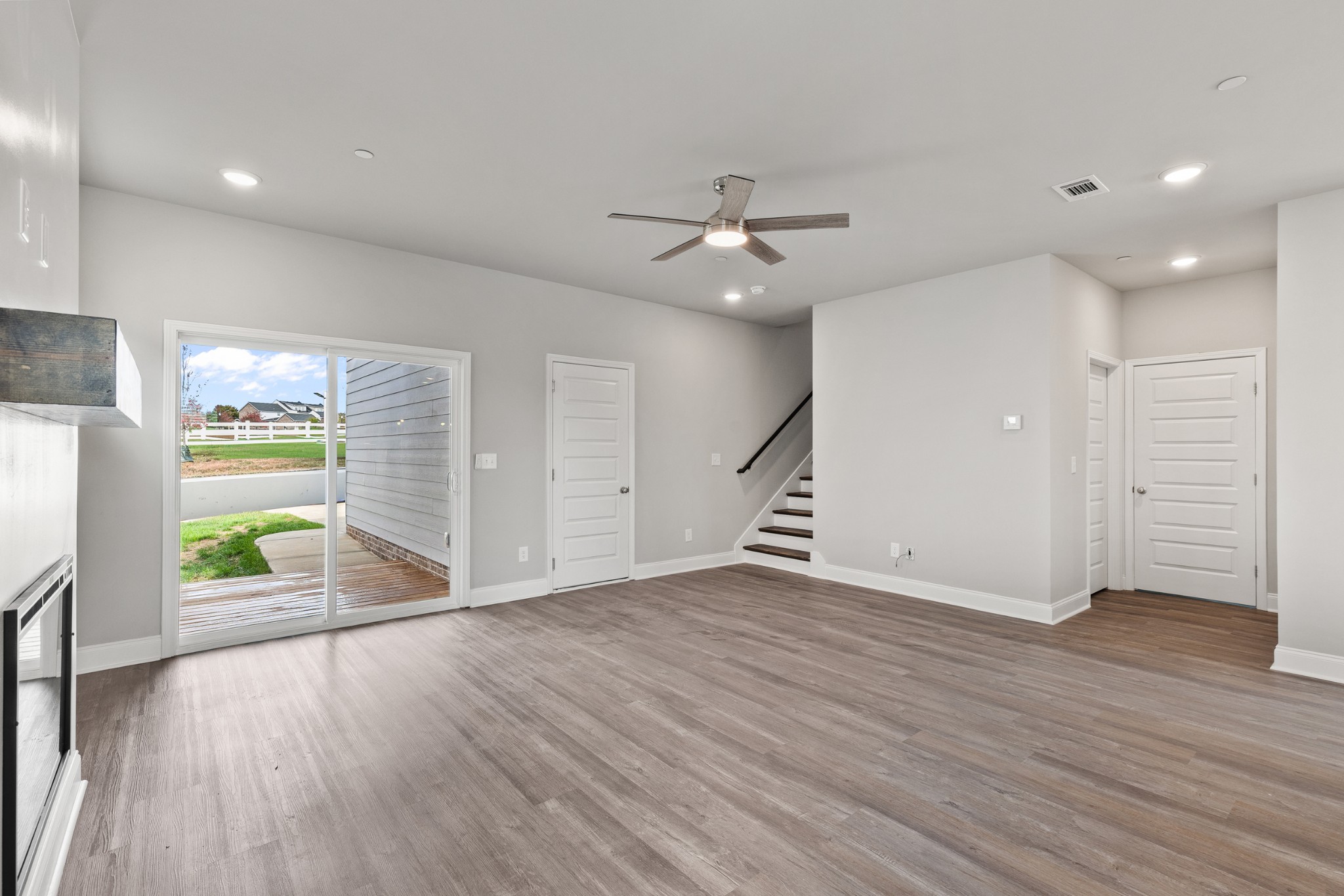 232 Franklin Street Pleasant View, TN 37146 - Photo 10 of 49 a view of a livingroom with a stove wooden floor and a ceiling fan