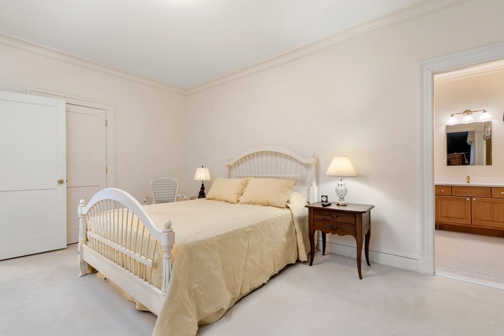 25 Bridle Pth Path Weston, MA 02493 - Photo 21 of 32 a bedroom with a bed and a view of en suite bathroom