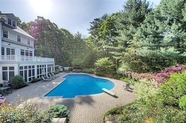 25 Bridle Pth Path Weston, MA 02493 - Photo 29 of 32 a view of a house with swimming pool and sitting area