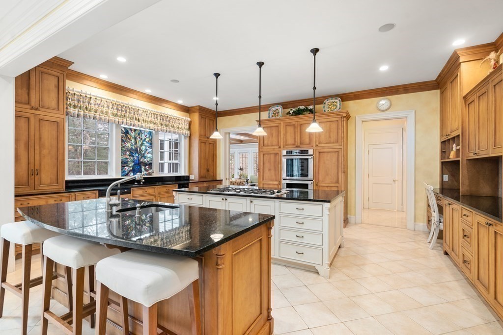 25 Bridle Pth Path Weston, MA 02493 - Photo 10 of 32 a kitchen with stainless steel appliances granite countertop a stove a sink and a refrigerator