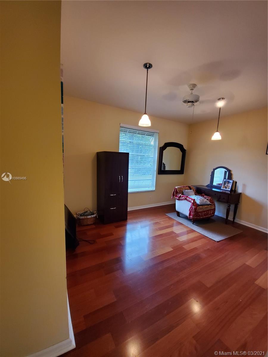 1405 Addison Avenue Boca Raton, FL 33486 - Photo 14 of 24 a living room with furniture and a wooden floor
