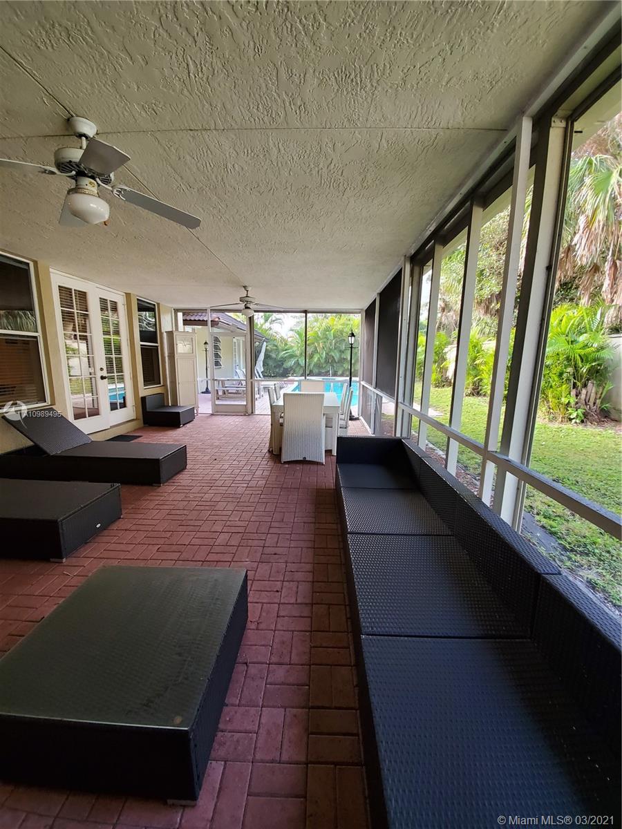 1405 Addison Avenue Boca Raton, FL 33486 - Photo 21 of 24 a living room with furniture and a floor to ceiling window