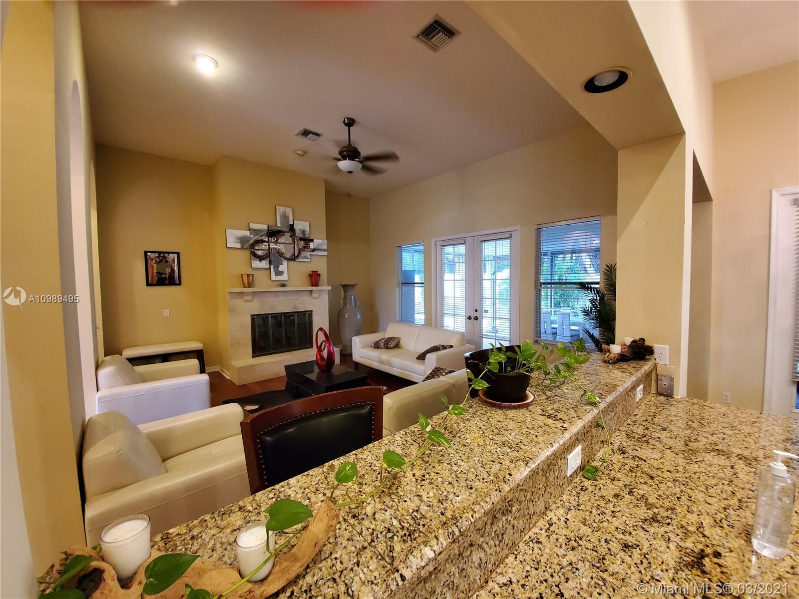 1405 Addison Avenue Boca Raton, FL 33486 - Photo 7 of 24 a living room with furniture fireplace and a window
