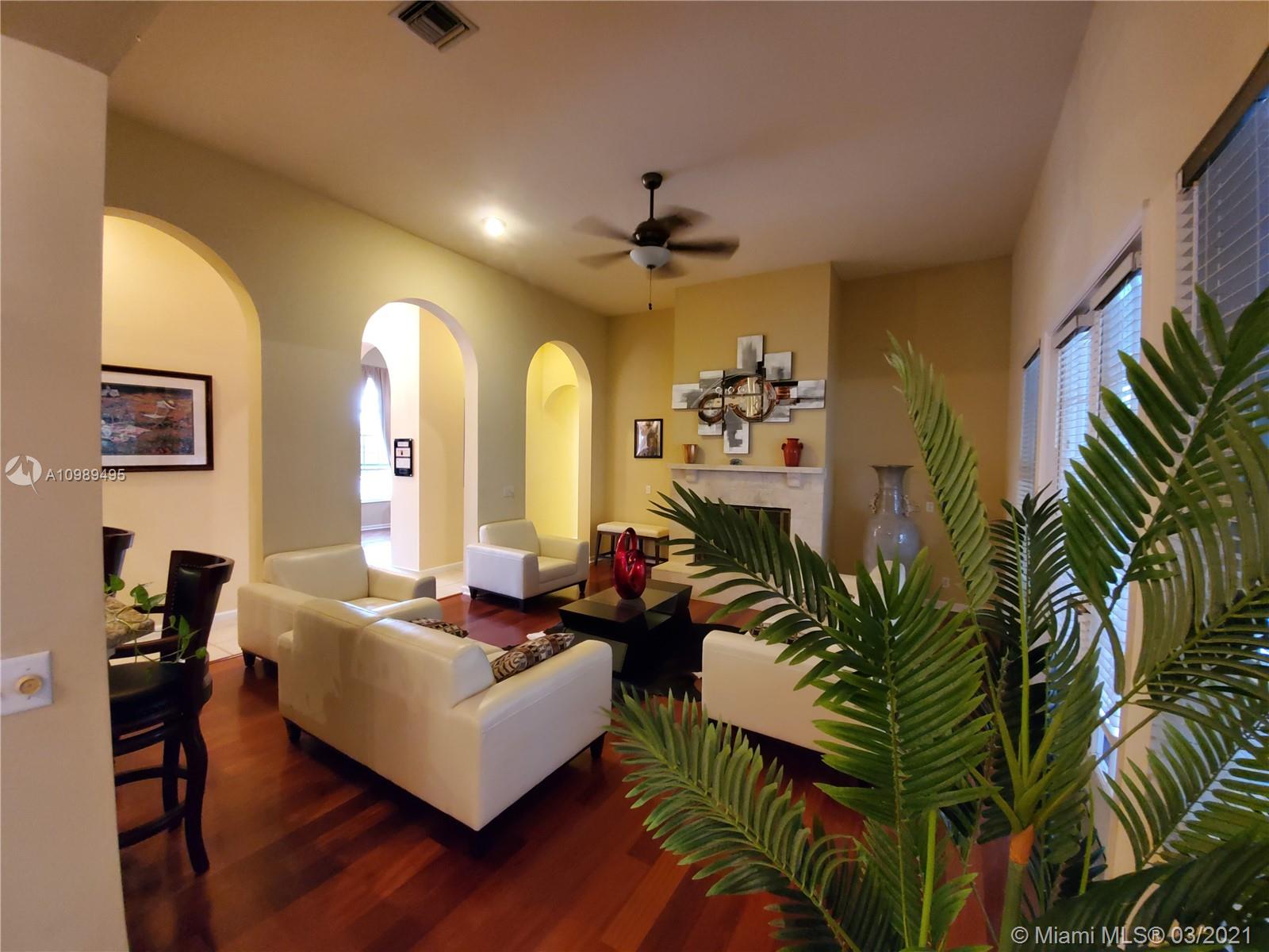 1405 Addison Avenue Boca Raton, FL 33486 - Photo 8 of 24 a living room with furniture and a potted plant