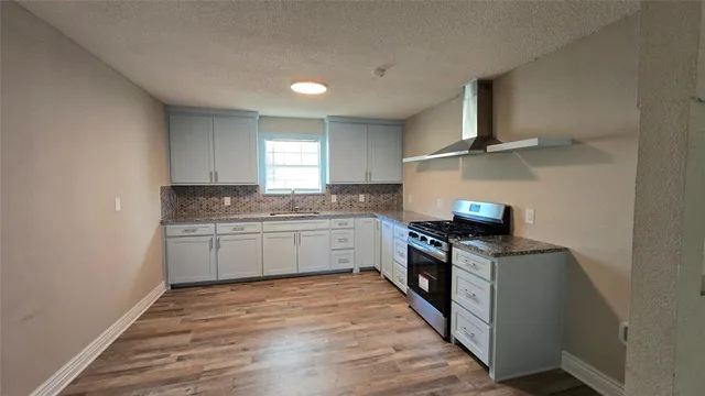 a kitchen with a stove top oven sink and cabinets