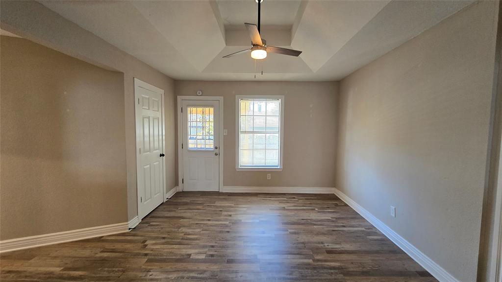 1441 Oakley Avenue Dallas, TX 75216 - Photo 14 of 34 a view of an empty room with window and wooden floor
