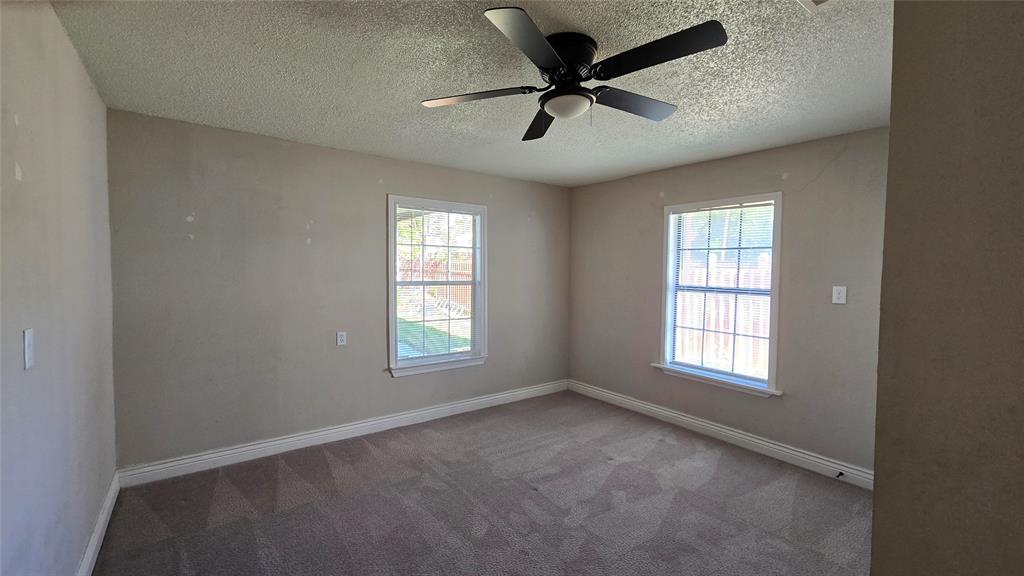 1441 Oakley Avenue Dallas, TX 75216 - Photo 17 of 34 an empty room with a window and a fan
