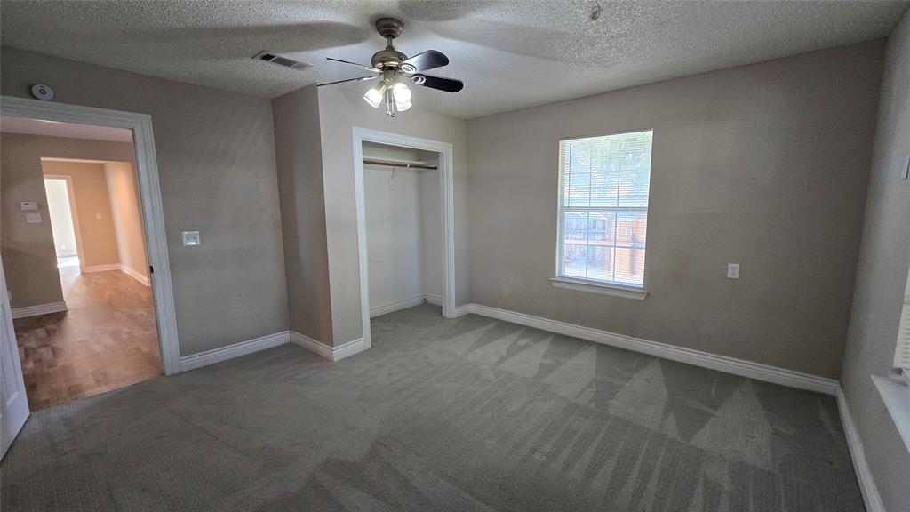 1441 Oakley Avenue Dallas, TX 75216 - Photo 21 of 34 an empty room with windows and fan