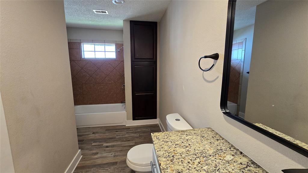 1441 Oakley Avenue Dallas, TX 75216 - Photo 22 of 34 a bathroom with a toilet and a shower