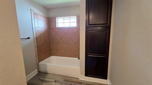 a bathroom with a bathtub and a shower