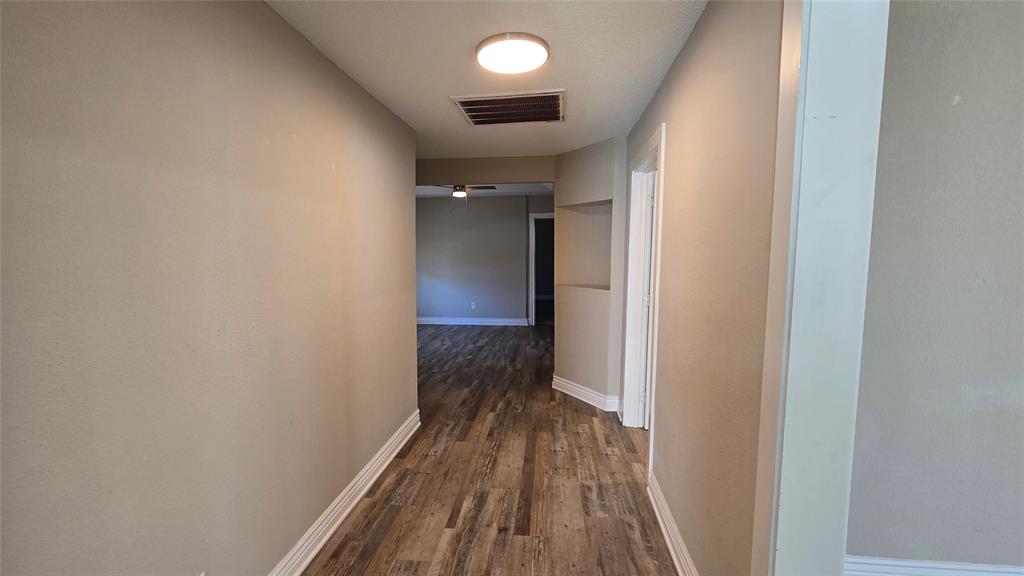 1441 Oakley Avenue Dallas, TX 75216 - Photo 24 of 34 a view of a hallway with wooden floor