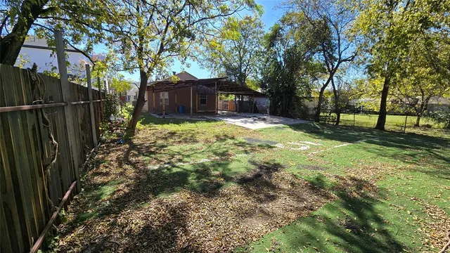 a view of a backyard with large trees