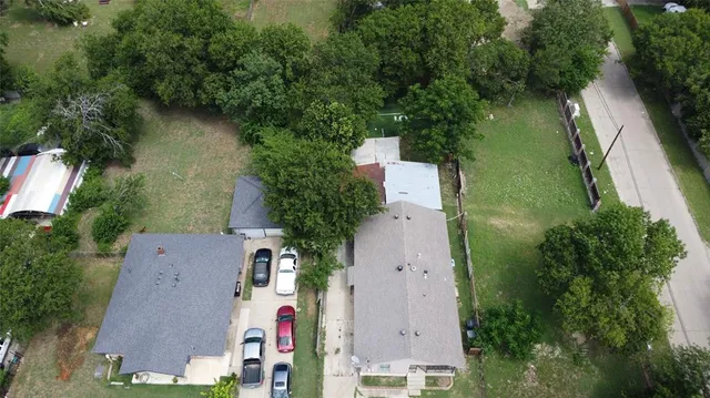 an aerial view of house with yard and outdoor seating