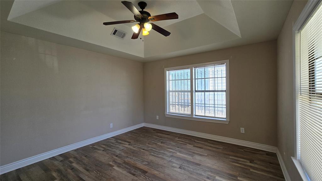 1441 Oakley Avenue Dallas, TX 75216 - Photo 5 of 34 an empty room with wooden floor fan and windows