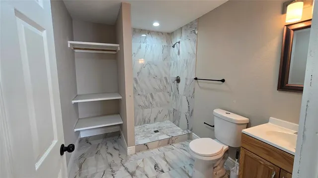 a bathroom with a toilet and a shower
