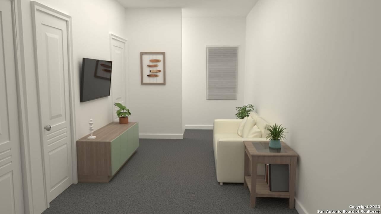 a room with furniture and a potted plant