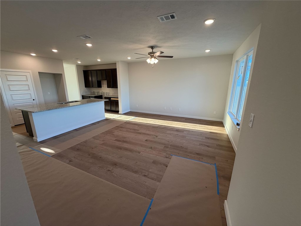 215 Whaley Street Caldwell, TX 77836 - Photo 7 of 14 a view of a kitchen with a sink and a refrigerator