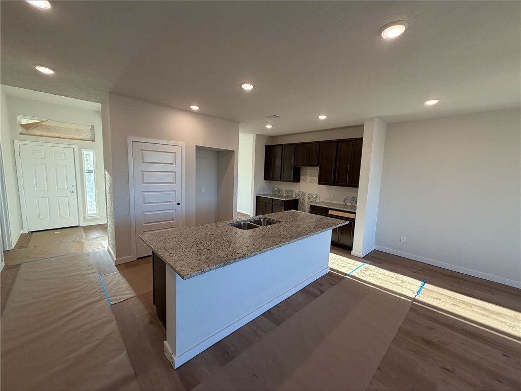 215 Whaley Street Caldwell, TX 77836 - Photo 8 of 14 a kitchen with stainless steel appliances granite countertop a sink a stove and a refrigerator