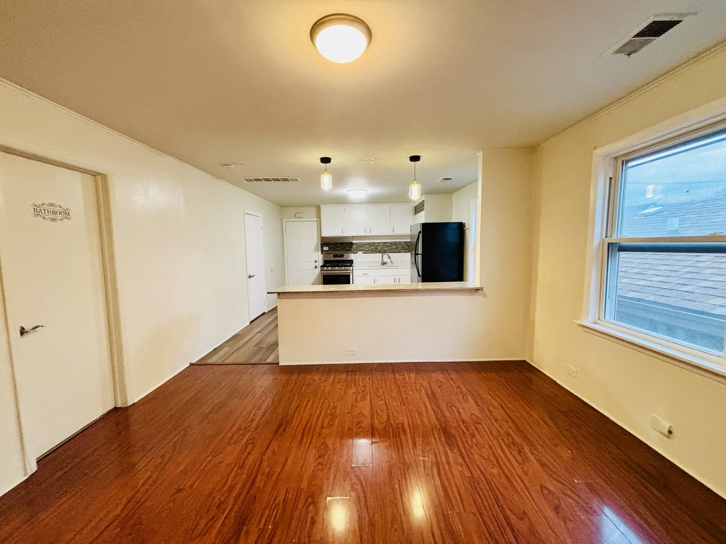 4541 South Lowe Avenue, Unit 2R Chicago, IL 60609 - Photo 2 of 10 a view of a kitchen with wooden floor and electronic appliances