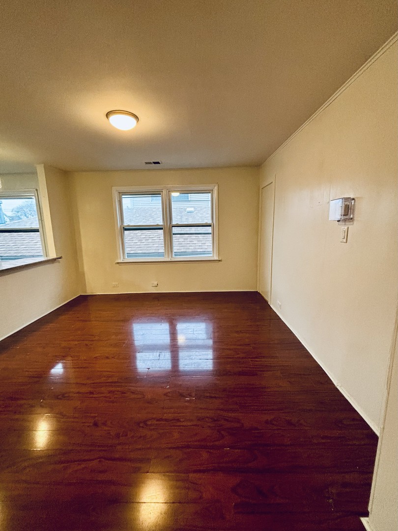4541 South Lowe Avenue, Unit 2R Chicago, IL 60609 - Photo 3 of 10 a view of empty room with wooden floor and fan