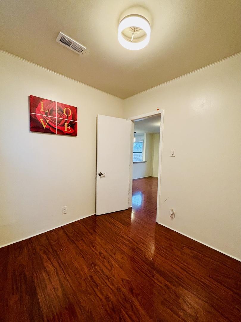 4541 South Lowe Avenue, Unit 2R Chicago, IL 60609 - Photo 7 of 10 an empty room with wooden floor