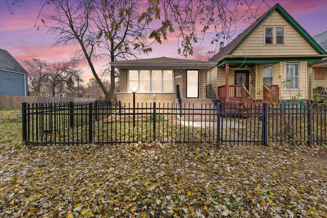 a front view of a house with a fence