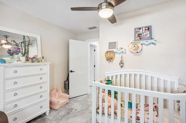 a bedroom with furniture and baby crib