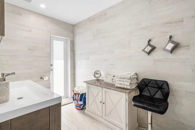 a bathroom with a sink mirror and shower