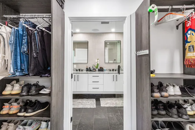 a bathroom with a double vanity sink mirror and shower