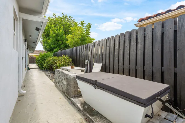 a view of a chair and table in the garden