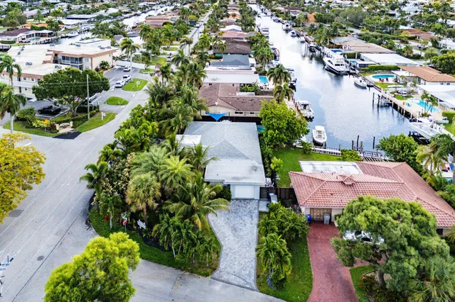 an aerial view of a house with garden space and lake view