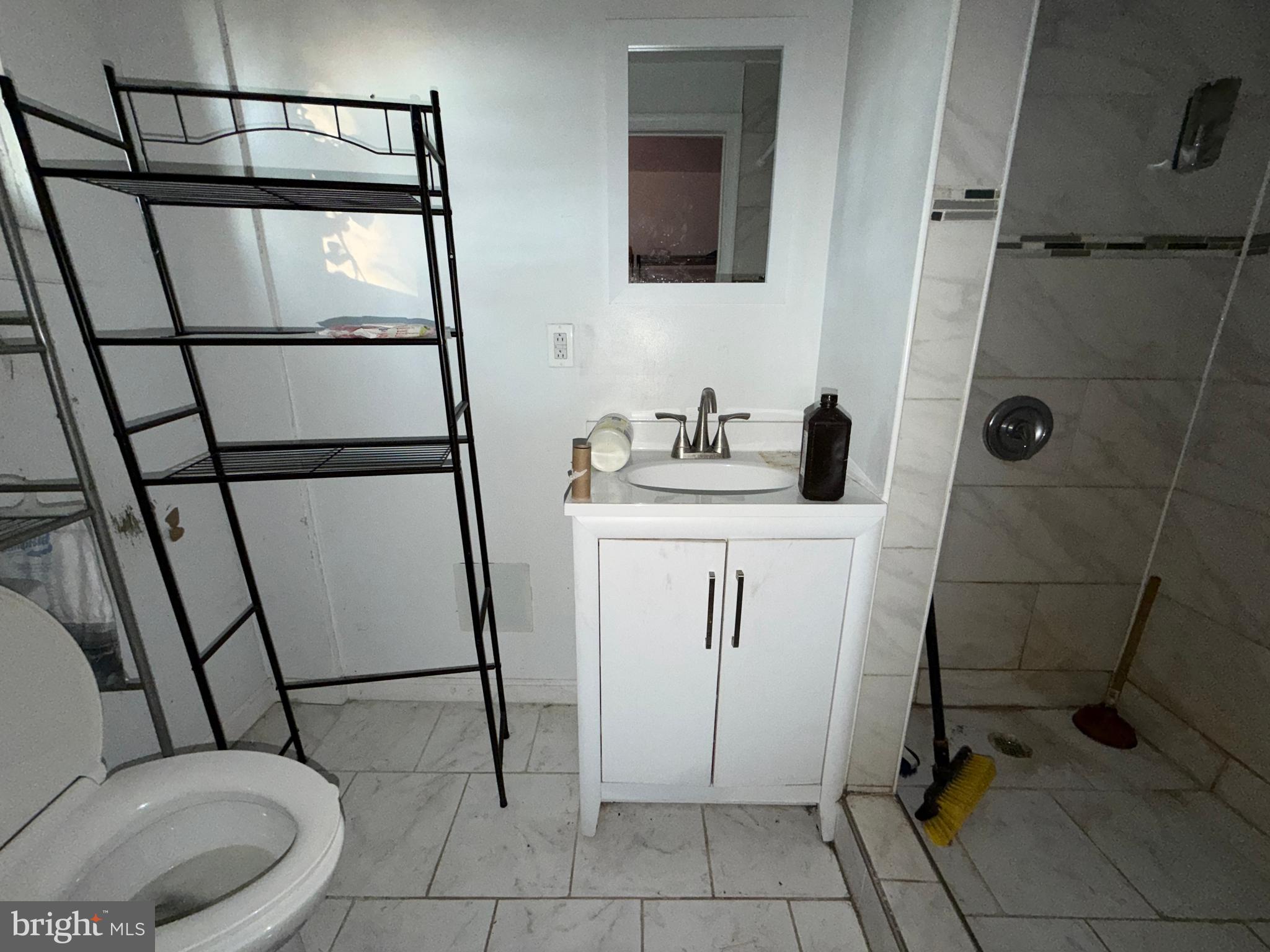 910 North Dukeland Street Baltimore, MD 21216 - Photo 18 of 27 a bathroom with a sink toilet and shower