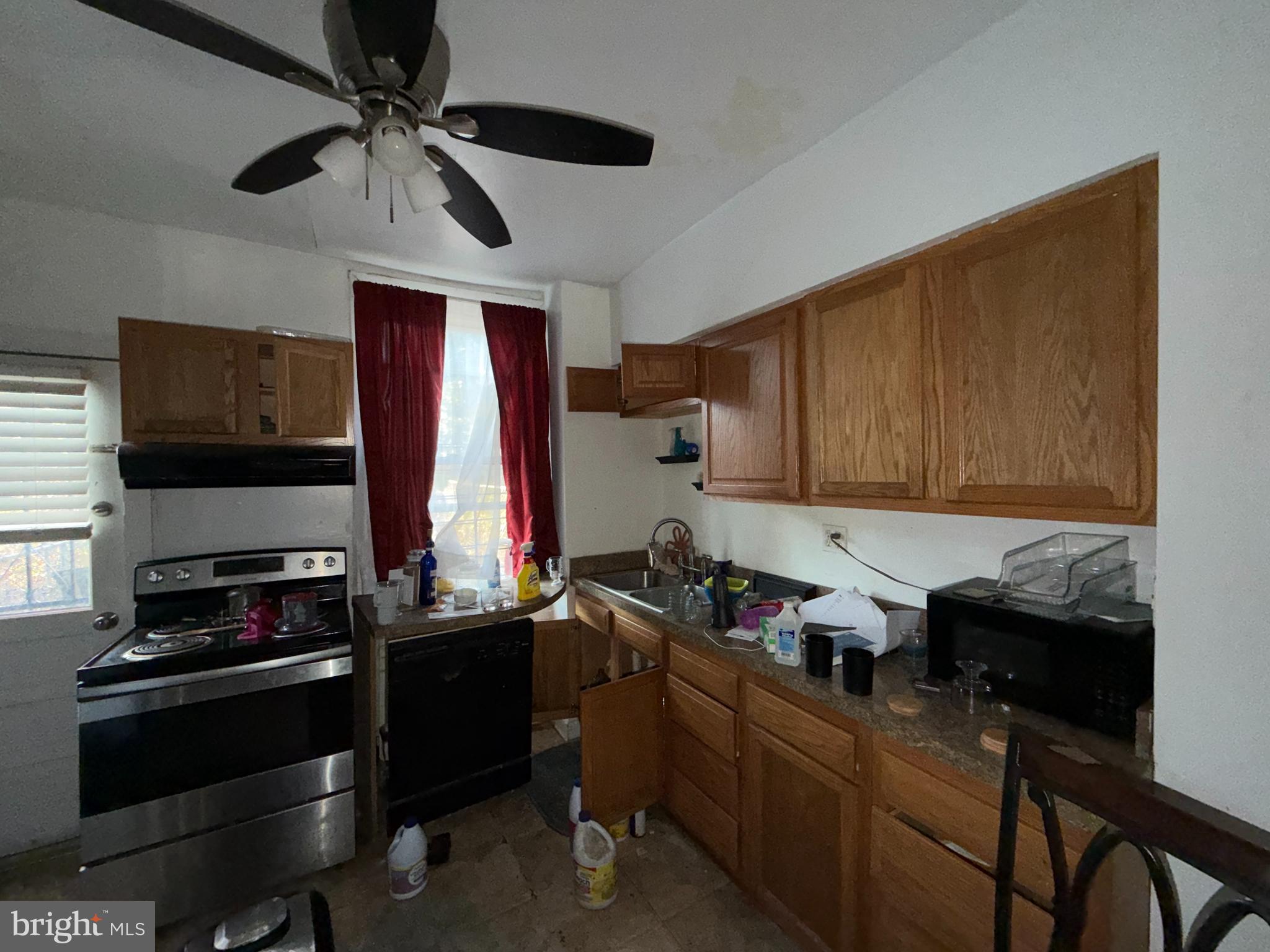 910 North Dukeland Street Baltimore, MD 21216 - Photo 8 of 27 a kitchen with a stove a refrigerator and a microwave