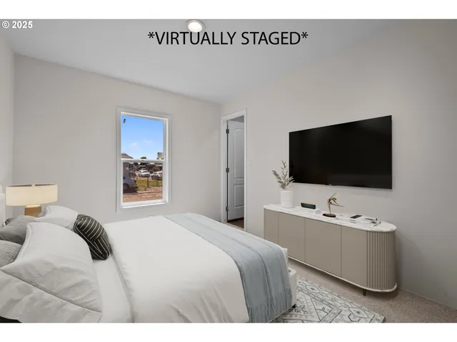 a bedroom with a bed and a flat screen tv