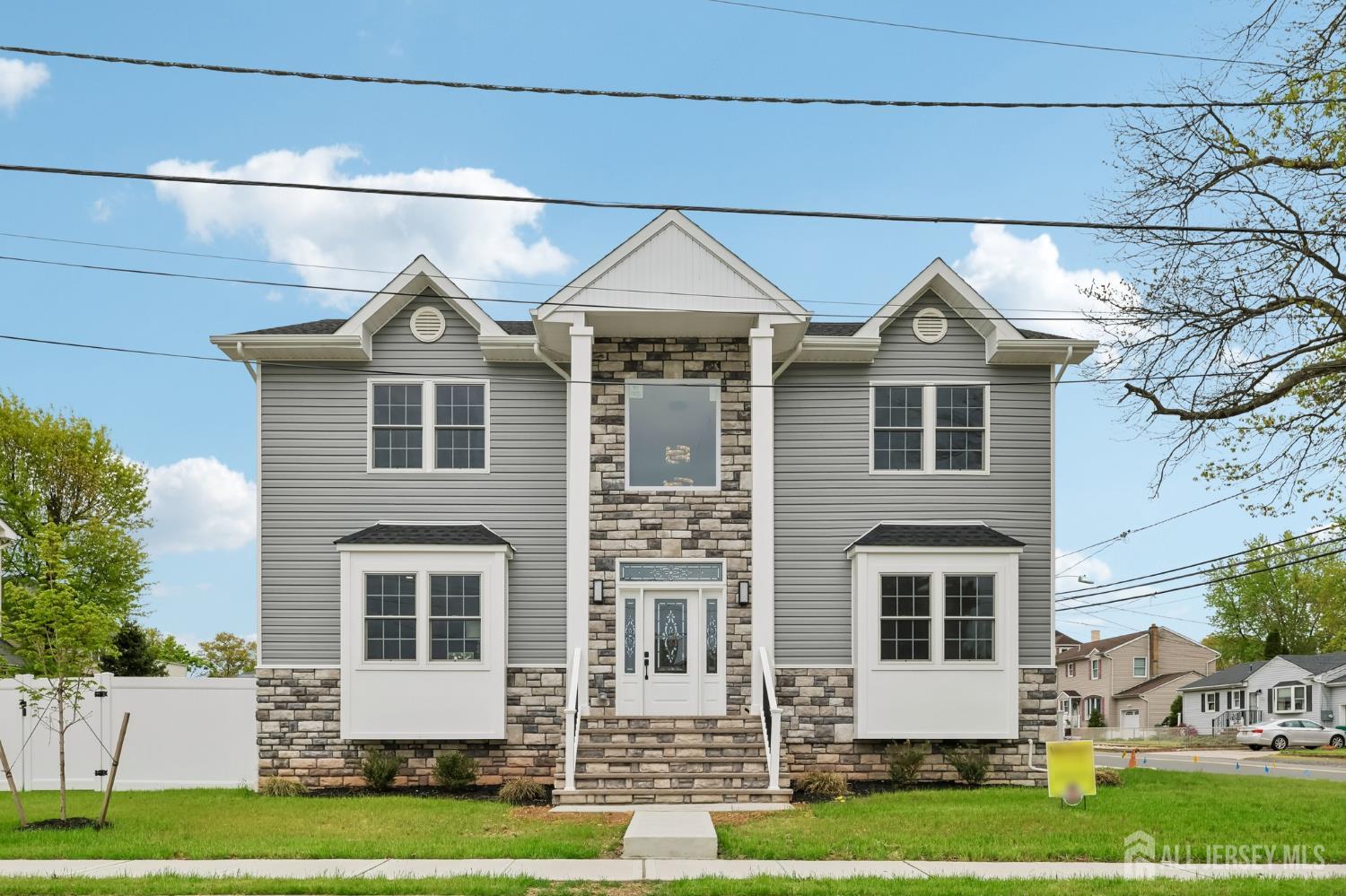 239 Suttons Lane Edison, NJ 08817 - Photo 2 of 68 a front view of a house with a yard
