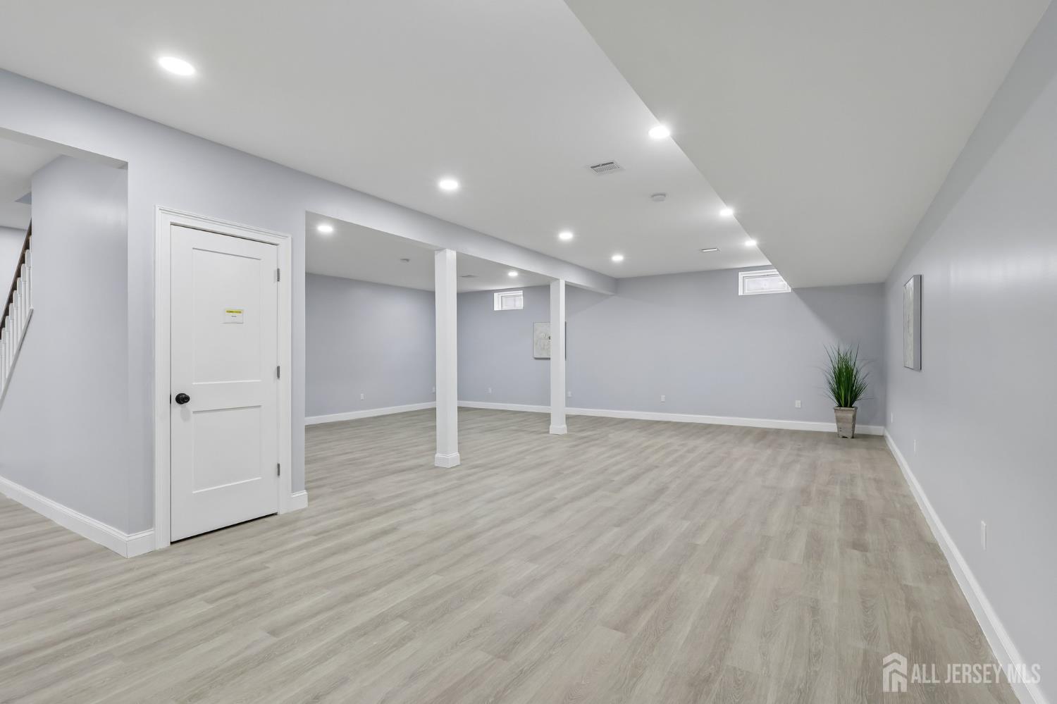 239 Suttons Lane Edison, NJ 08817 - Photo 24 of 68 a view of an empty room with wooden floor