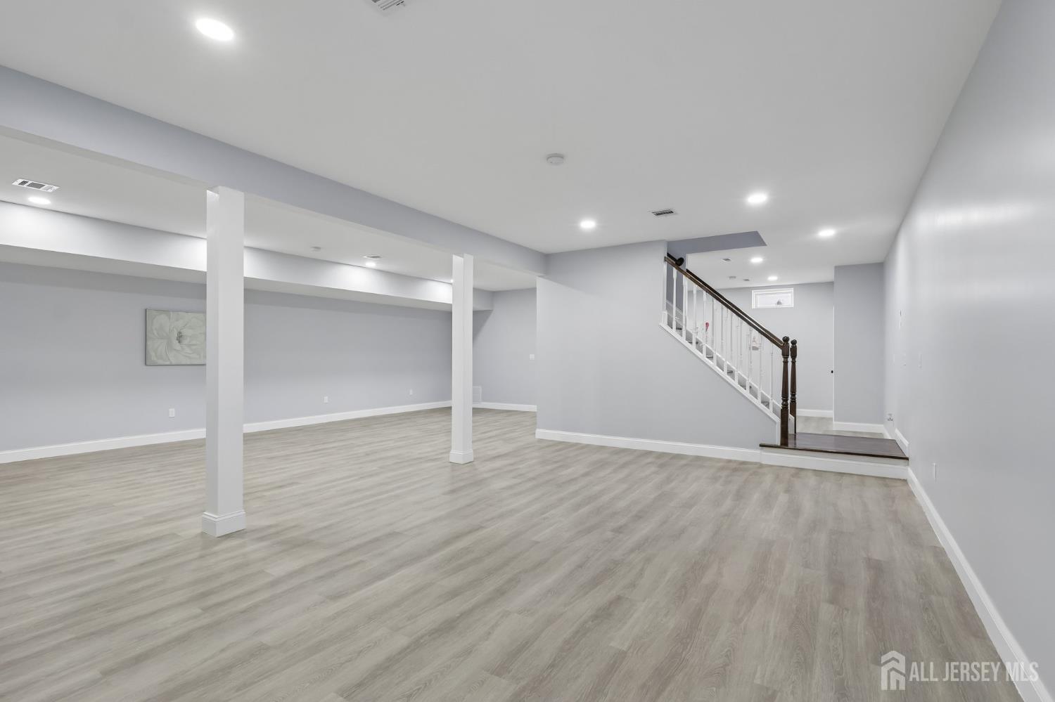 239 Suttons Lane Edison, NJ 08817 - Photo 26 of 68 a view of an empty room with wooden floor