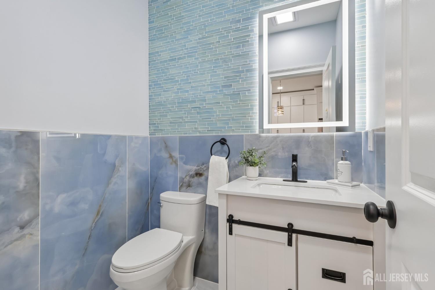 239 Suttons Lane Edison, NJ 08817 - Photo 27 of 68 a bathroom with a sink a toilet and mirror