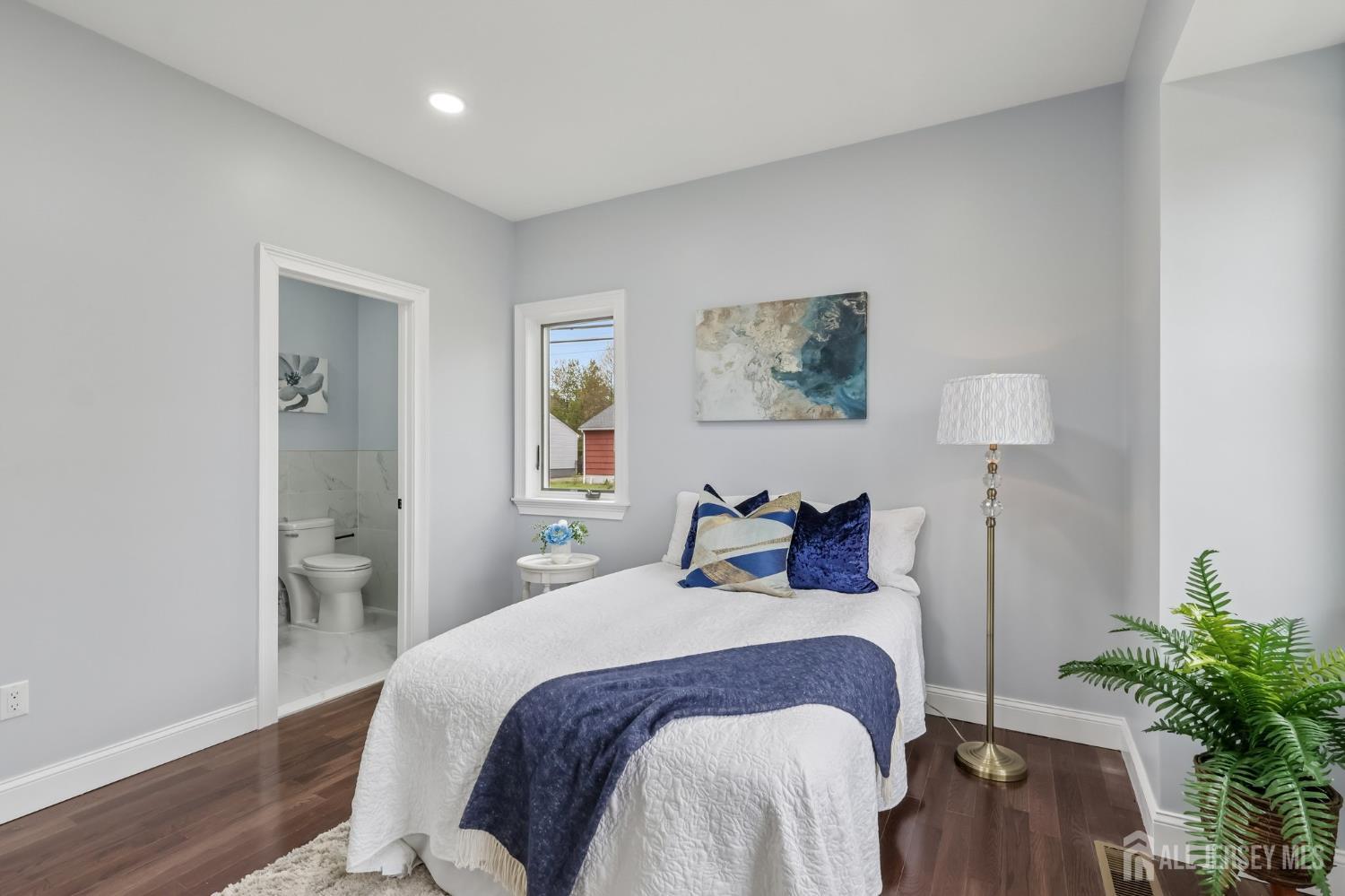 239 Suttons Lane Edison, NJ 08817 - Photo 30 of 68 a bedroom with a bed and a potted plant