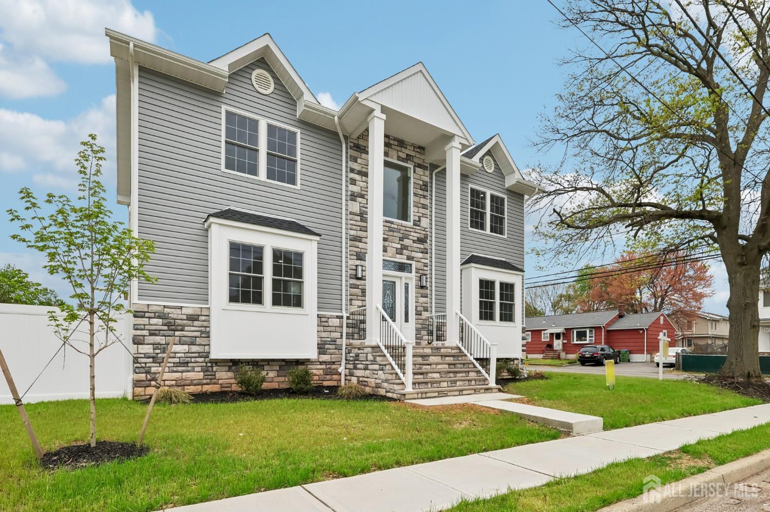 239 Suttons Lane Edison, NJ 08817 - Photo 3 of 68 a front view of a house with a yard