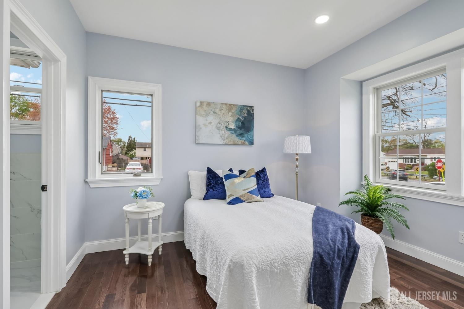 239 Suttons Lane Edison, NJ 08817 - Photo 31 of 68 a bedroom with a bed and a potted plant