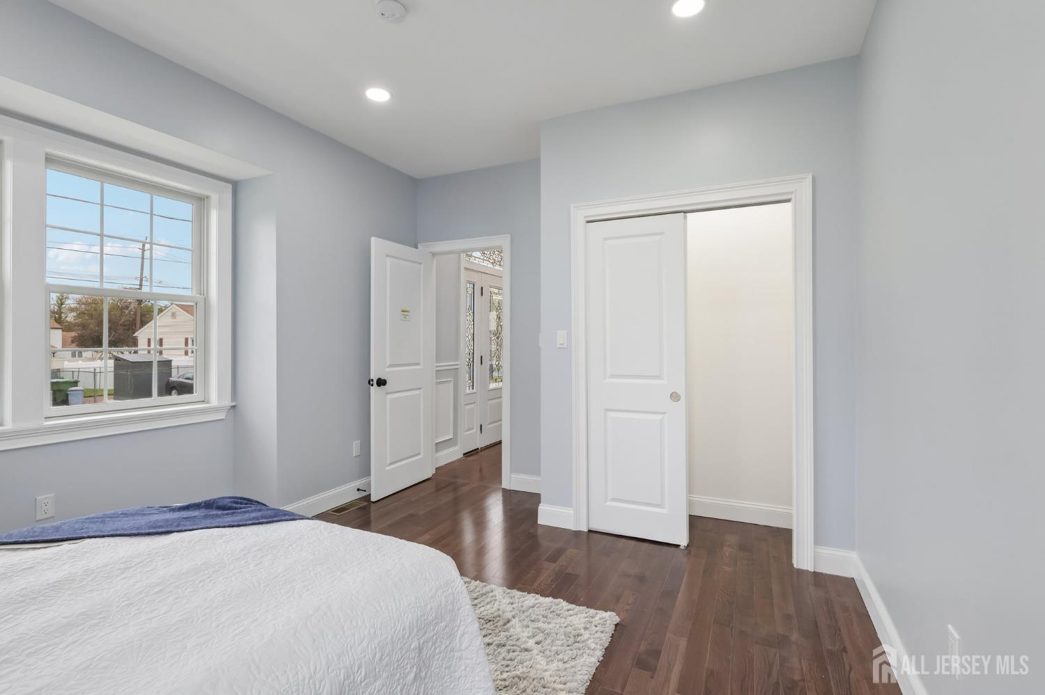 239 Suttons Lane Edison, NJ 08817 - Photo 33 of 68 a bedroom with a bed and wooden floor