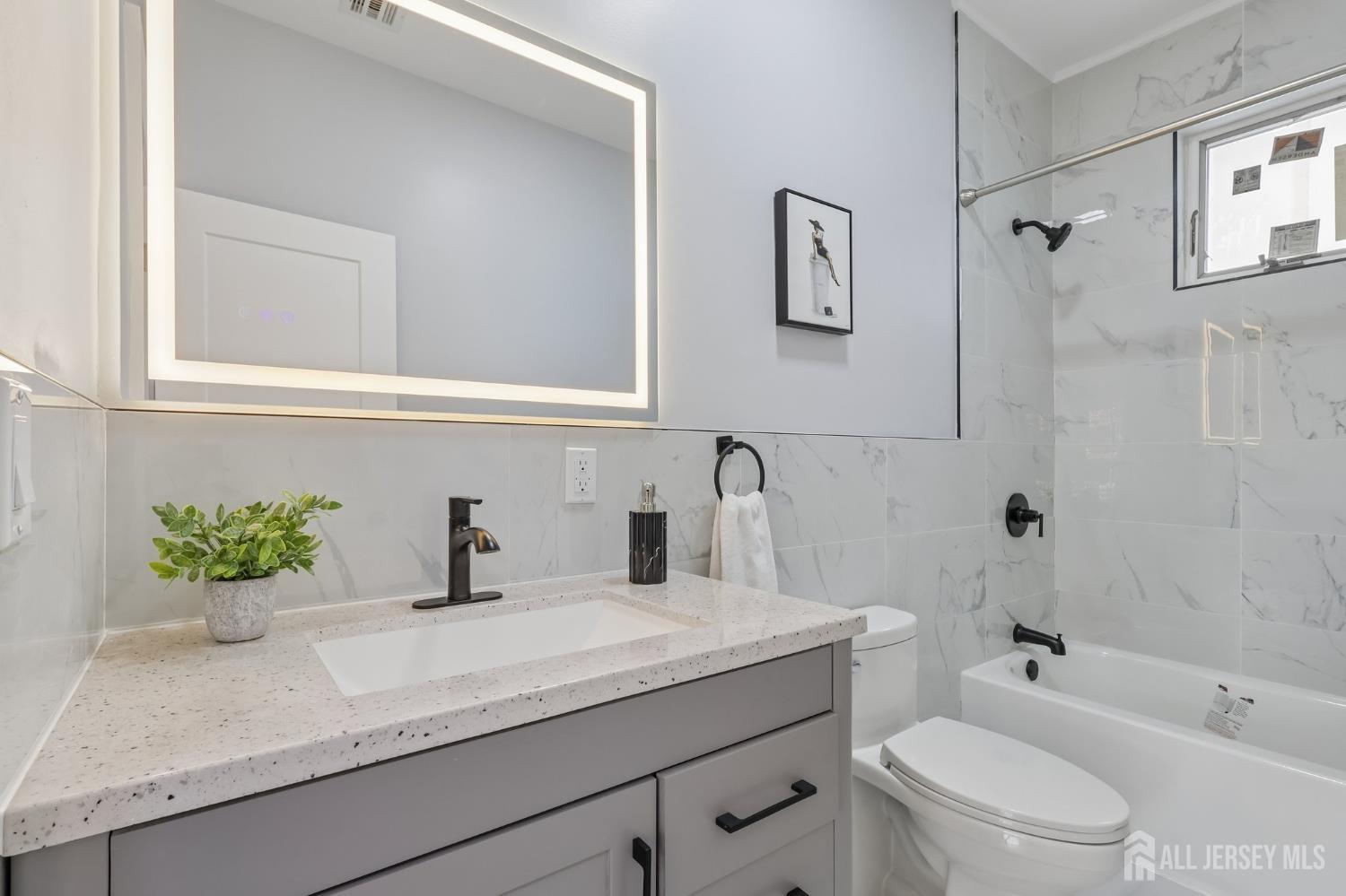 239 Suttons Lane Edison, NJ 08817 - Photo 36 of 68 a bathroom with a granite countertop sink a toilet and shower