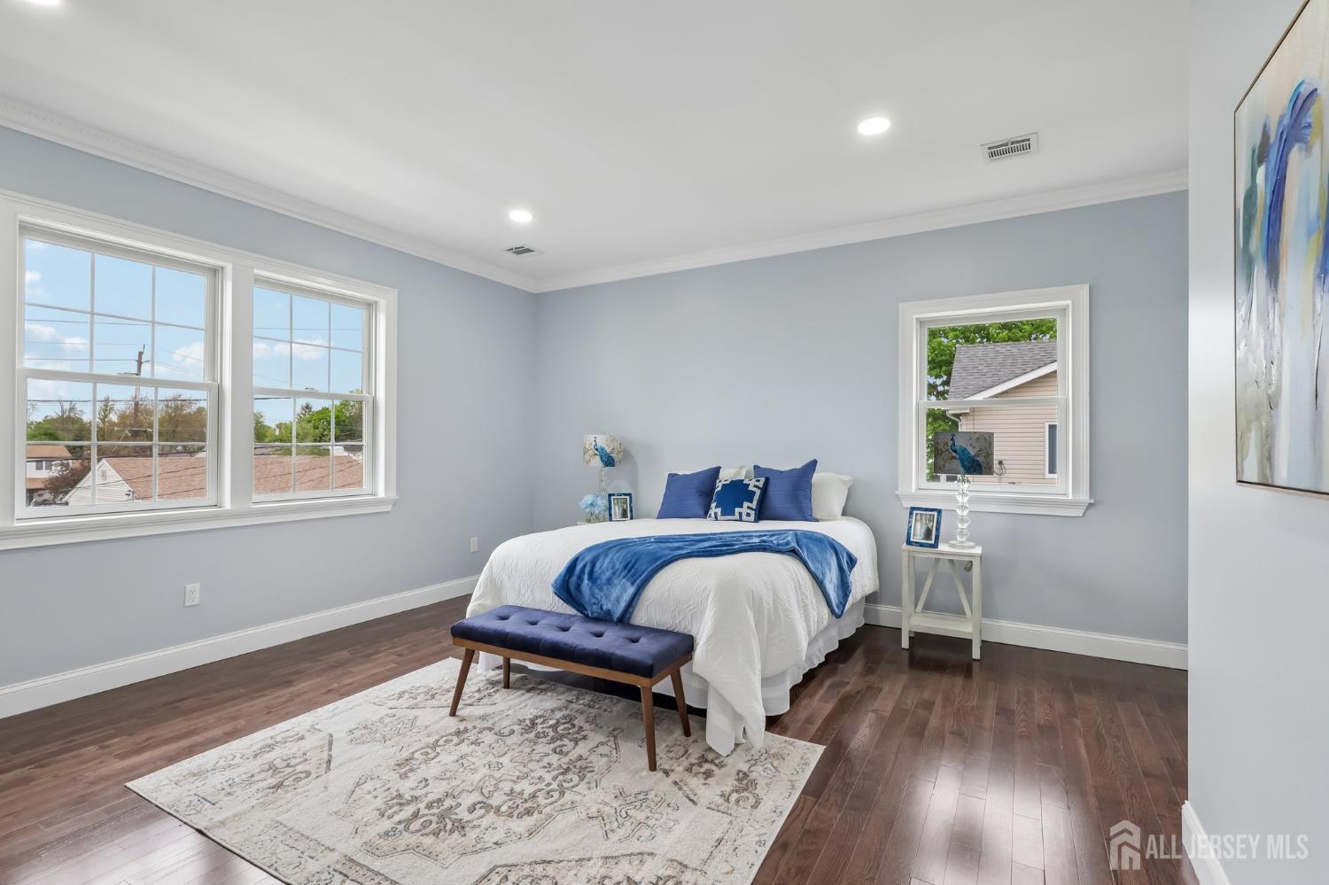 239 Suttons Lane Edison, NJ 08817 - Photo 39 of 68 a spacious bedroom with a bed and wooden floor