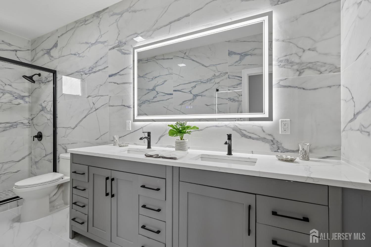 239 Suttons Lane Edison, NJ 08817 - Photo 43 of 68 a bathroom with a double vanity sink toilet and a mirror