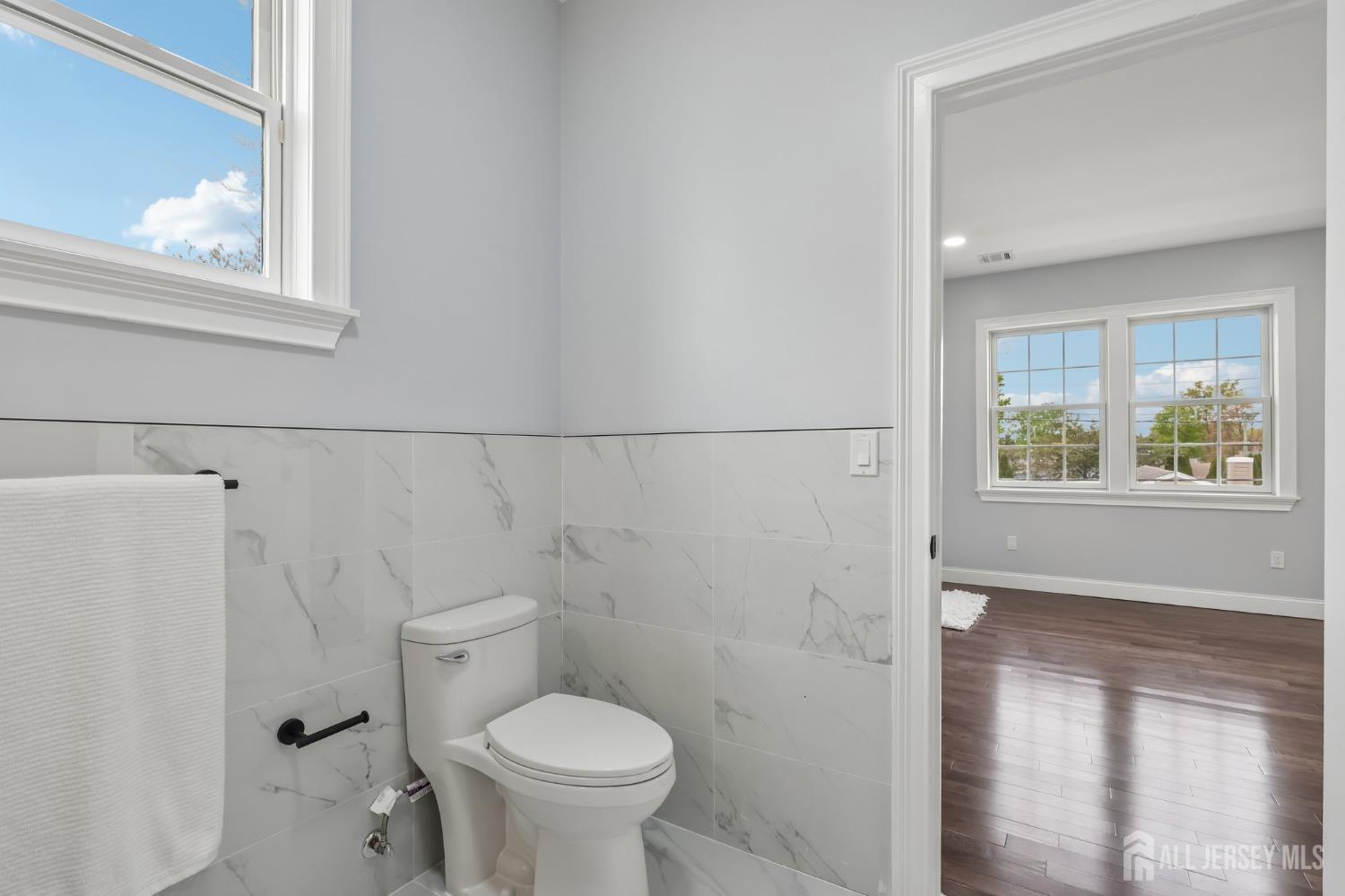 239 Suttons Lane Edison, NJ 08817 - Photo 47 of 68 a bathroom with a toilet a sink and a window
