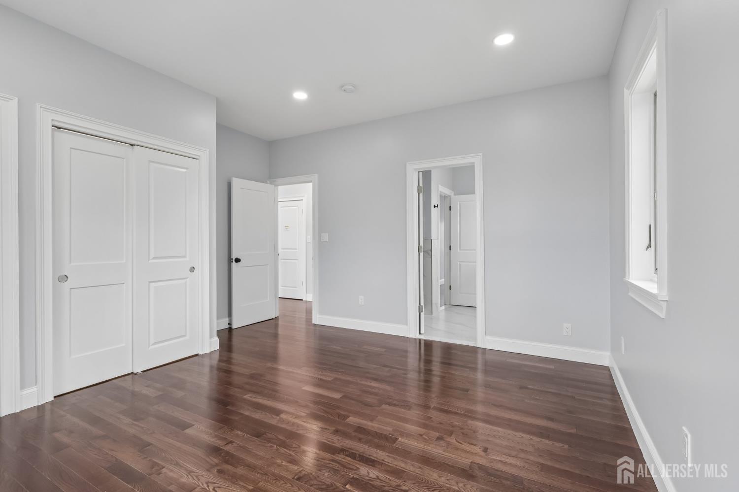 239 Suttons Lane Edison, NJ 08817 - Photo 56 of 68 a view of an empty room with wooden floor