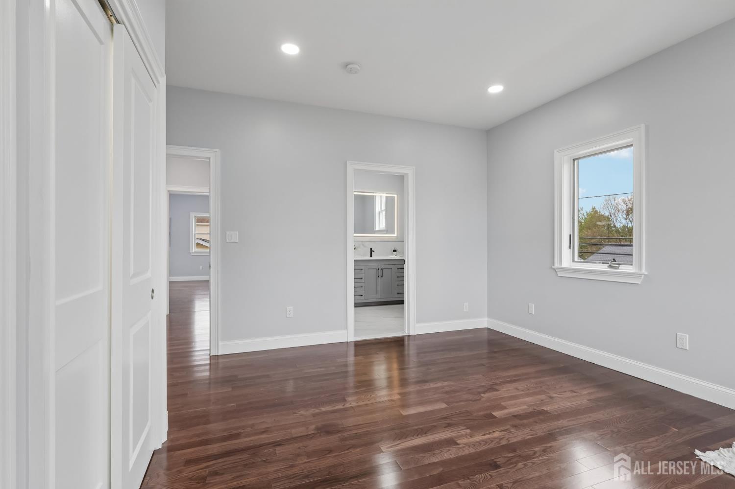 239 Suttons Lane Edison, NJ 08817 - Photo 57 of 68 an empty room with wooden floor and windows