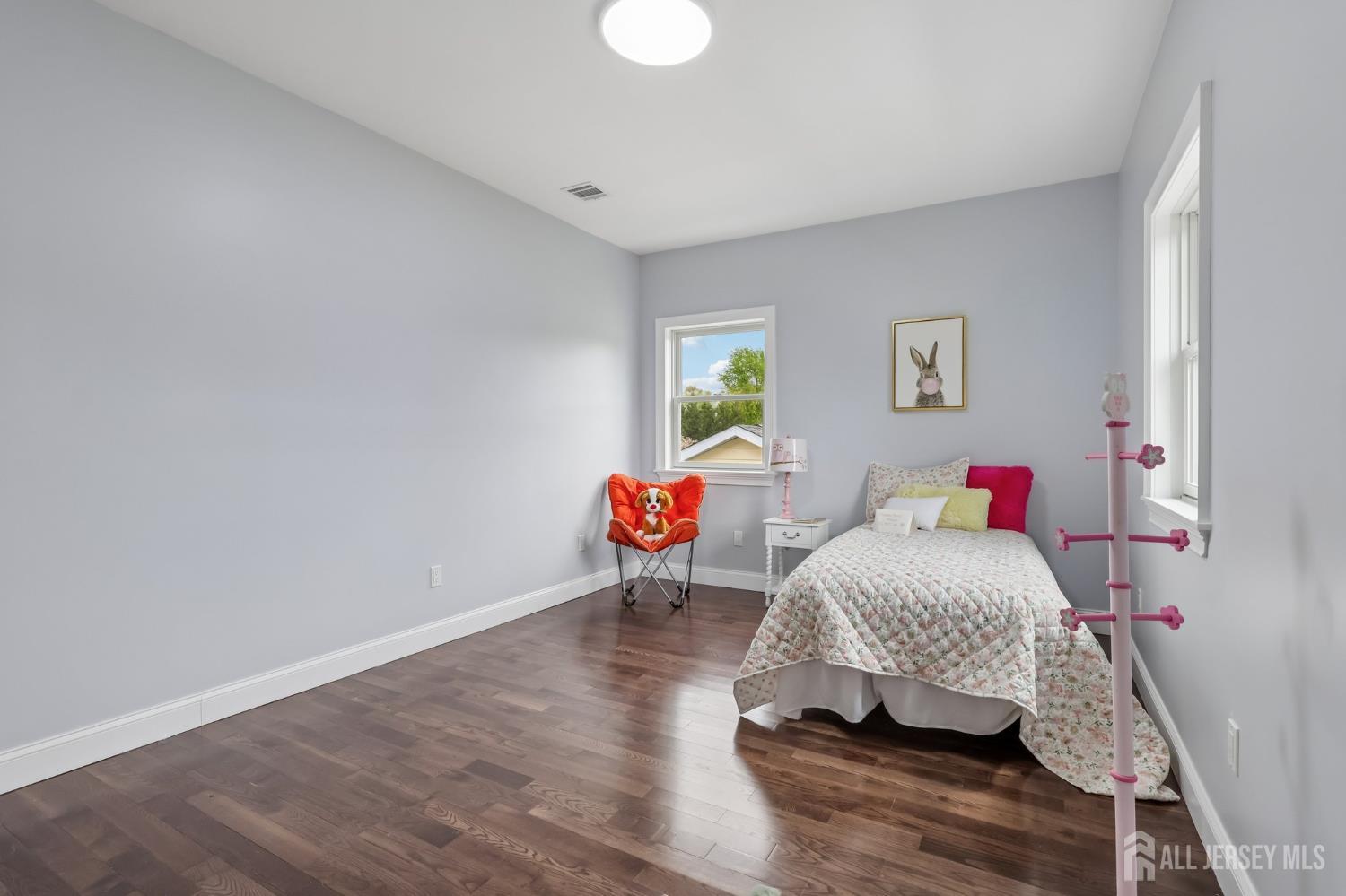239 Suttons Lane Edison, NJ 08817 - Photo 60 of 68 a living room with furniture and a wooden floor