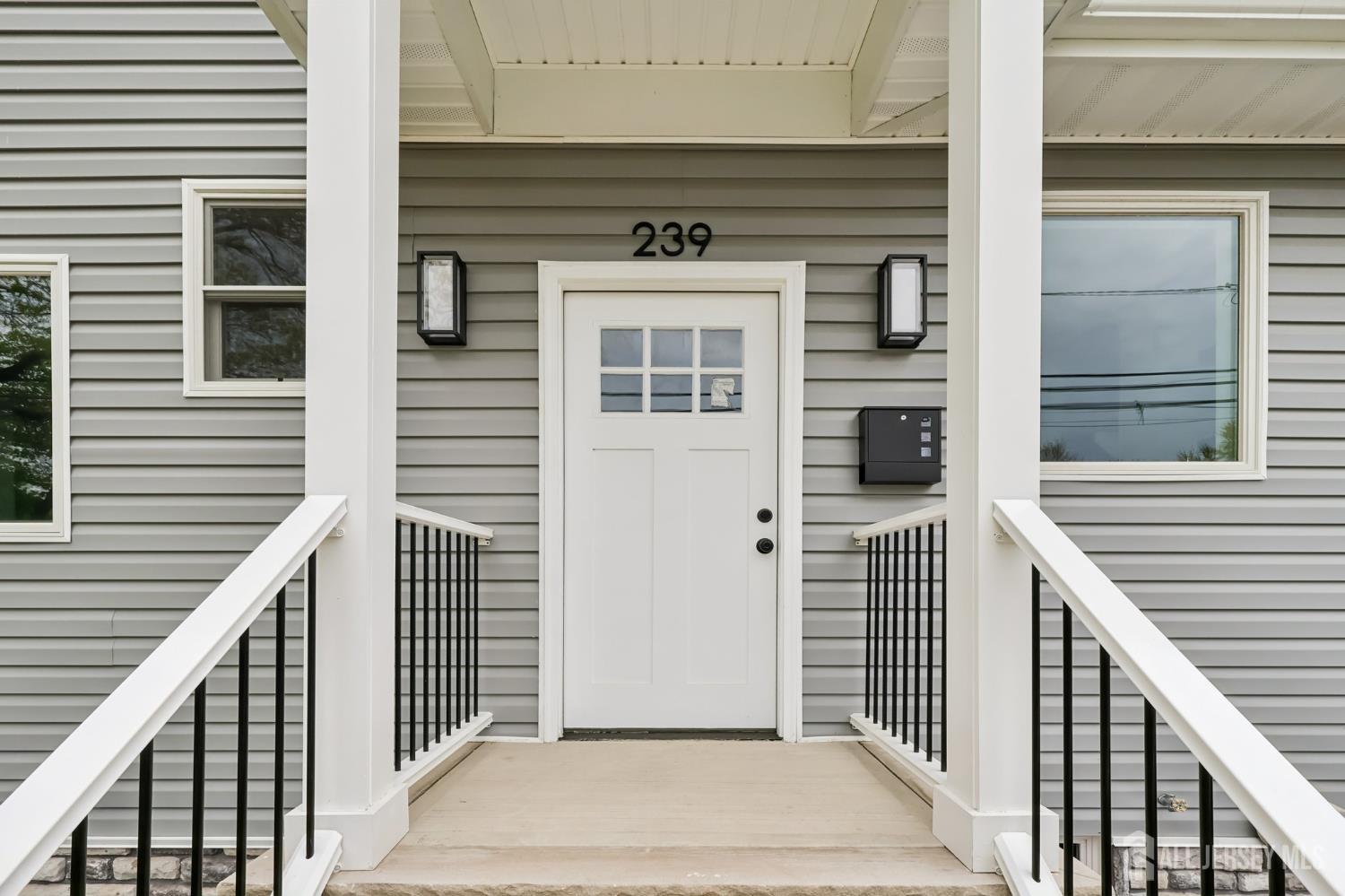 239 Suttons Lane Edison, NJ 08817 - Photo 9 of 68 a front view of a house with a door and a window